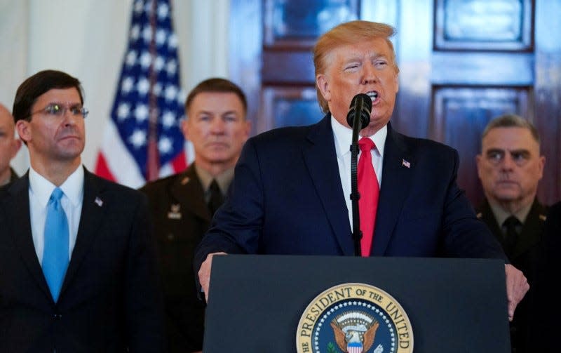 FILE PHOTO: U.S. President Donald Trump delivers a statement about Iran flanked by U.S. Defense Secretary Mark Esper, Army Chief of Staff General James McConville and Chairman of the Joint Chiefs of Staff Army General Mark Milley in the Grand Foyer at the White House in Washington, U.S., January 8, 2020. REUTERS/Kevin Lamarque 