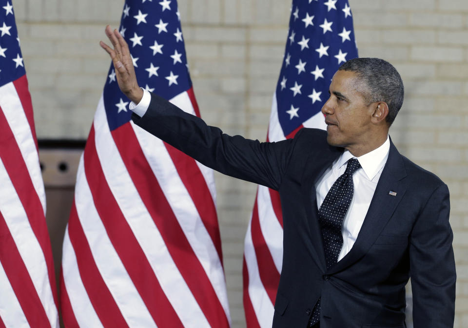 President Barack Obama acknowledges the crowd, Wednesday, Feb. 26, 2014 at the Union Depot in St. Paul, Minn. President Barack Obama said Wednesday he will ask Congress for $300 billion to update aging roads and railways, arguing that the taxpayer investment is a worthy one that will pay dividends by attracting businesses and helping put people to work. (AP Photo/Jim Mone)