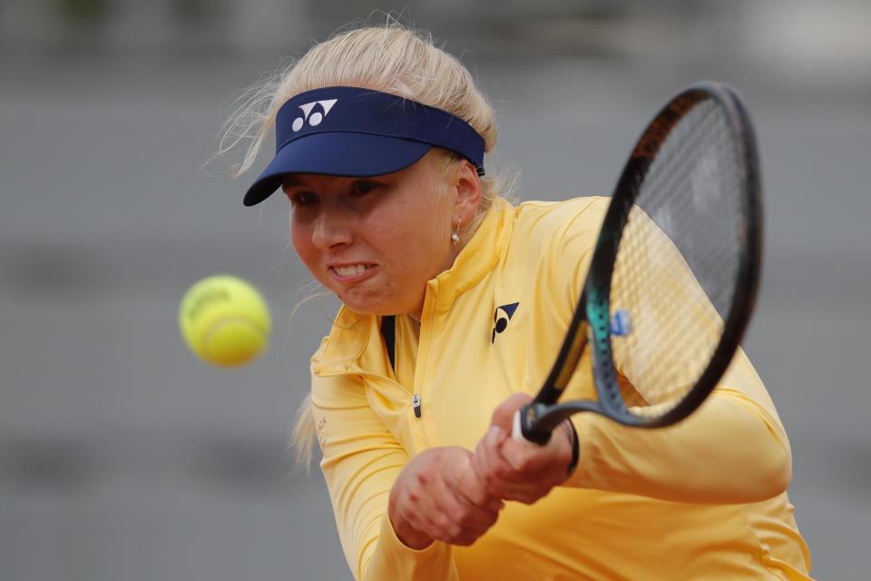 FILE - In this file photo dated Thursday, Oct. 1, 2020, Denmark's Clara Tauson plays a shot against Danielle Collins of the U.S. in the second round match of the French Open tennis tournament at the Roland Garros stadium in Paris, France. Danish teenager Clara Tauson continued her remarkable form at the Lyon Open, beating seventh-seeded Paula Badosa of Spain 7-5, 6-1 on Saturday March 6, 2021, to set up a first career final against fellow qualifier Viktorija Golubic. (AP Photo/Christophe Ena, FILE)