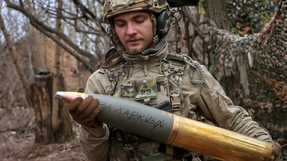 A Ukrainian serviceman prepares a shell inscribed "for Kharkiv" in Donetsk in April. - Sofiia Gatilova/Reuters