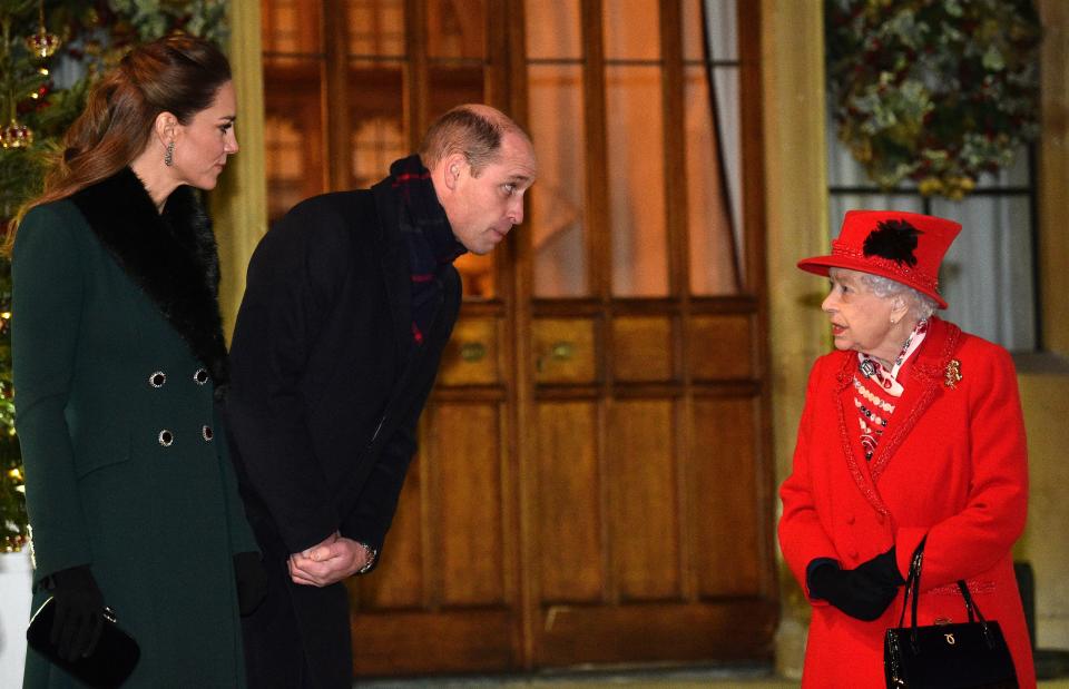 Britain's Queen Elizabeth II (R) talks with Britain's Prince William, Duke of Cambridge, (2L) and Britain's Catherine, Duchess of Cambridge, as they wait to thank local volunteers and key workers for the work they are doing during the coronavirus pandemic and over Christmas in the quadrangle of Windsor Castle in Windsor, west of London, on December 8, 2020 - The Queen and members of the royal family gave thanks to local volunteers and key workers for their work in helping others during the coronavirus pandemic and over Christmas at Windsor Castle in what was also the final stop for the Duke and Duchess of Cambridge on their tour of England, Wales and Scotland. (Photo by Glyn KIRK / POOL / AFP) (Photo by GLYN KIRK/POOL/AFP via Getty Images)