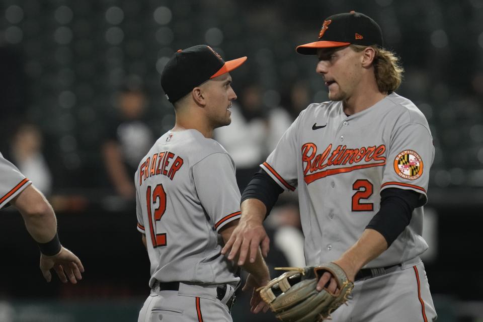 Baltimore Orioles second baseman Adam Frazier, left, and shortstop Gunnar Henderson celebrate after winning a baseball game against the Chicago White Sox, Friday, April 14, 2023, in Chicago. (AP Photo/Erin Hooley)