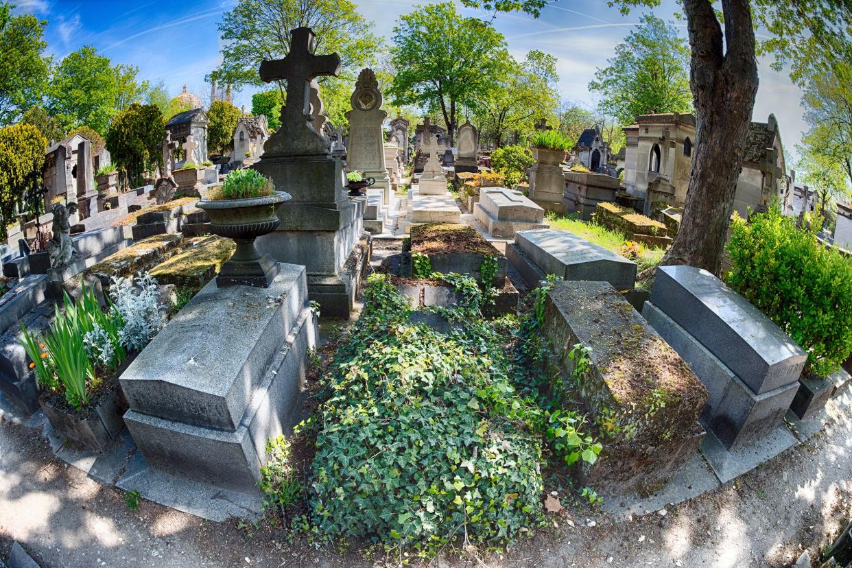 Several graves in Monumental Pere-Lachaise Cemetery, Paris, fisheye lens, on a sunny day in summer