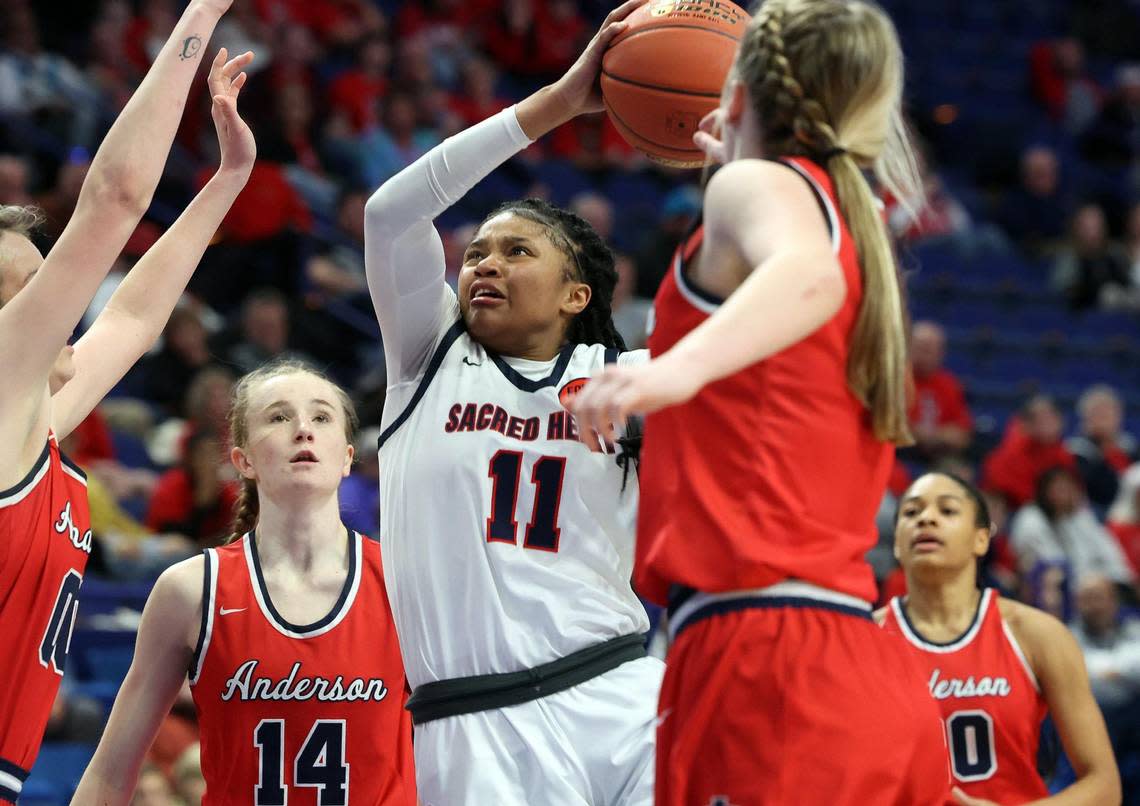 Sacred Heart’s ZaKiyah Johnson (11) shoots over Anderson County’s Paige Serafini (14) during the Girls’ Sweet 16 in Rupp Arena last March. Johnson is ranked as one of the top women’s college basketball recruits in the class of 2025. James Crisp