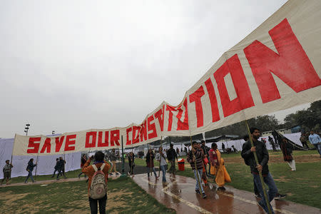 People carry a banner at an event titled "Artists Unite", during which various artists signed to register their concern against hate and intolerance, at a public park in New Delhi, March 2, 2019. REUTERS/Anushree Fadnavis/Files