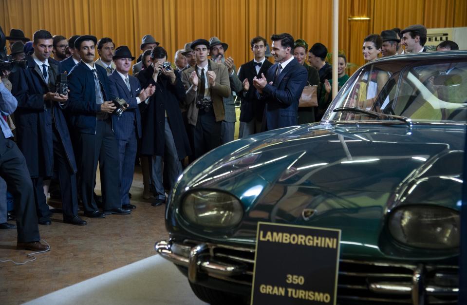 In this scene from "Lamborghini," onlookers at the 1963 Geneva Auto Show applaud the unveiling of the new Lamborghini 350 GT, the now famous automakers first vehicle.