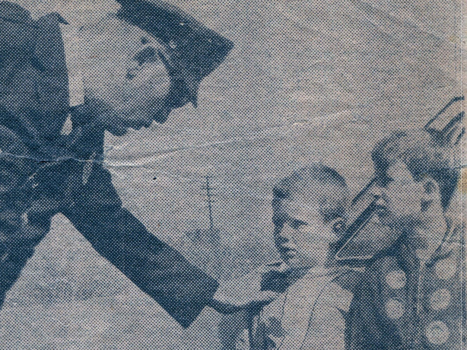 A  policeman talks with one of the boys who found John McCabes's body. 