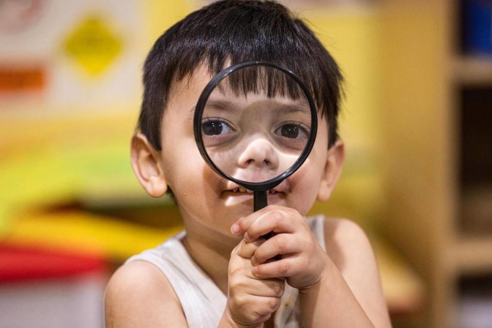 Student Carmine Arriago, 3, plays with a magnifying glass in the evening at the Future Scholars’ Childcare and Transportation child care home in Grand Prairie on Thursday, March 14, 2024. Future Scholars’ is one of few programs in Tarrant County that provide 24/7 child care. Chris Torres/ctorres@star-telegram.com