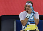 Greece's Stefanos Tsitsipas wipes the sweat from his eye during a break in his third round singles match against Canada's Milos Raonic at the Australian Open tennis championship in Melbourne, Australia, Friday, Jan. 24, 2020. (AP Photo/Andy Wong)