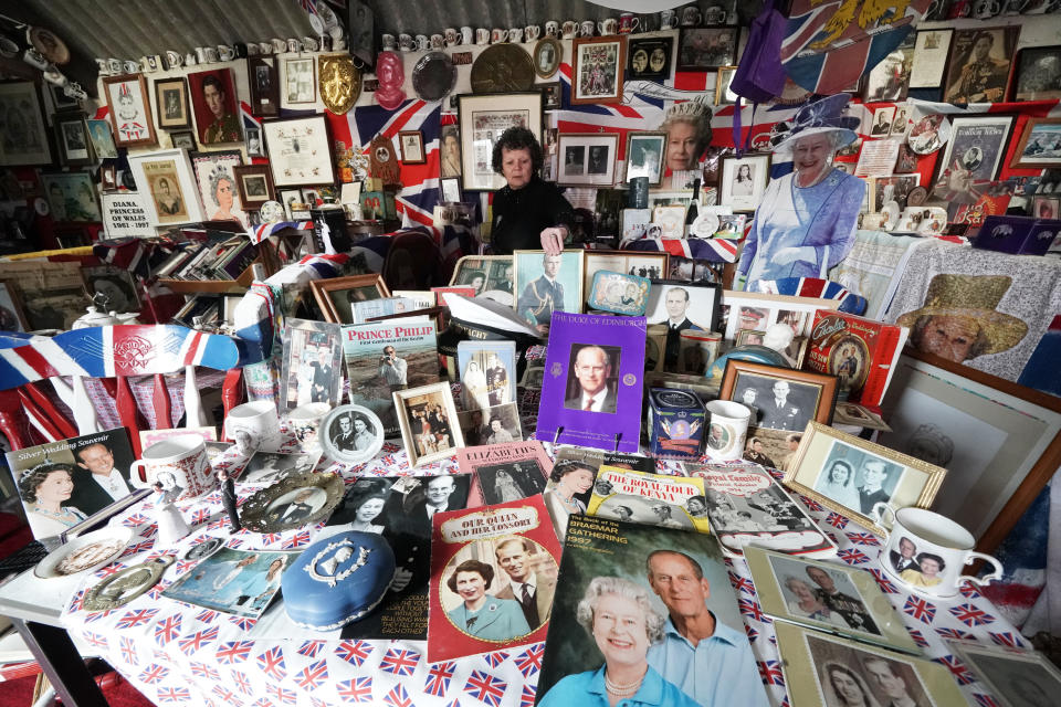 <p>Anita Atkinson arranging the Queen and the Duke of Edinburgh's section of her royal memorabilia collection, one of the biggest in the world, at her home in Crook, County Durham. The 64 year old says she was devastated to hear the news of the death of Prince Philip. Picture date: Tuesday April 13, 2021.</p>
