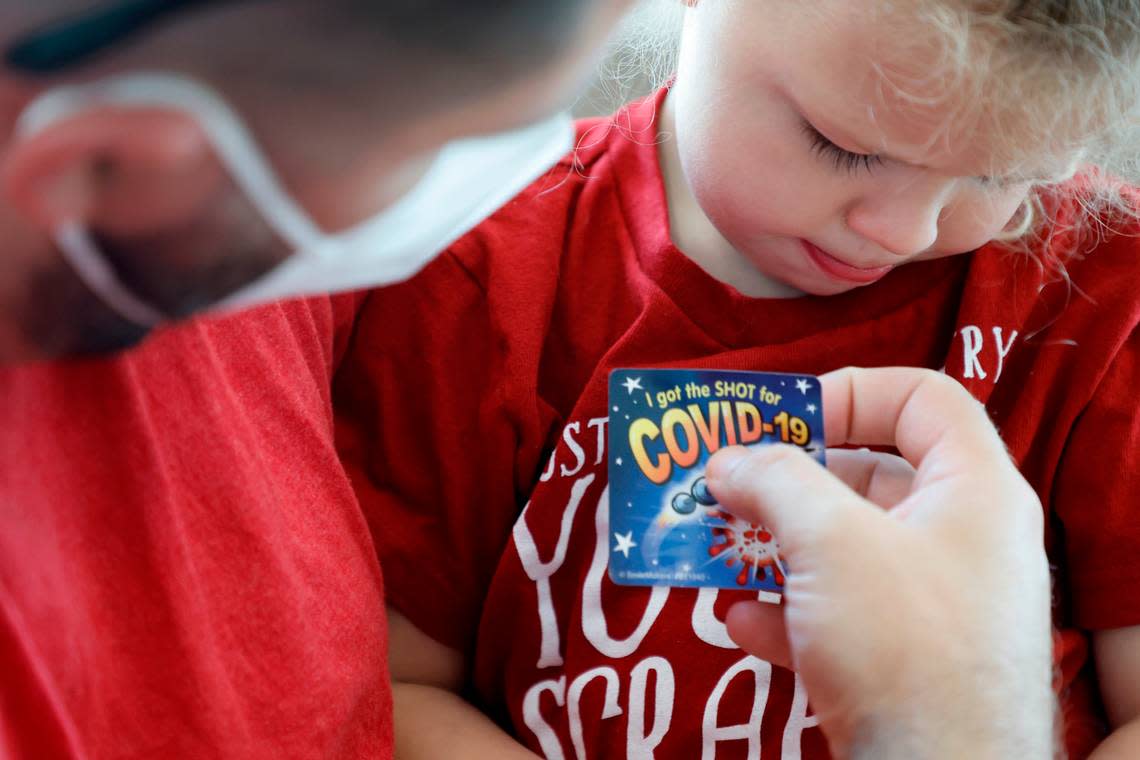 Jared Hocutt of Cary puts a ‘I got the shot’ sticker on his daughter, River, after she received the Moderna COVID-19 vaccine at UNC Family Medicine & Pediatrics at Panther Creek in Cary, N.C., on Friday, June 24, 2022. Ethan Hyman/ehyman@newsobserver.com