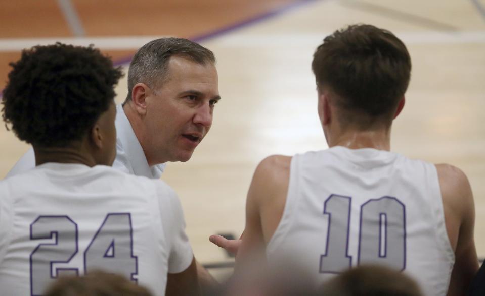 North Kitsap head coach Scott Orness talks with his son Cade (10) on the bench during their game against Bainbridge on Friday, Jan 19, 2024.