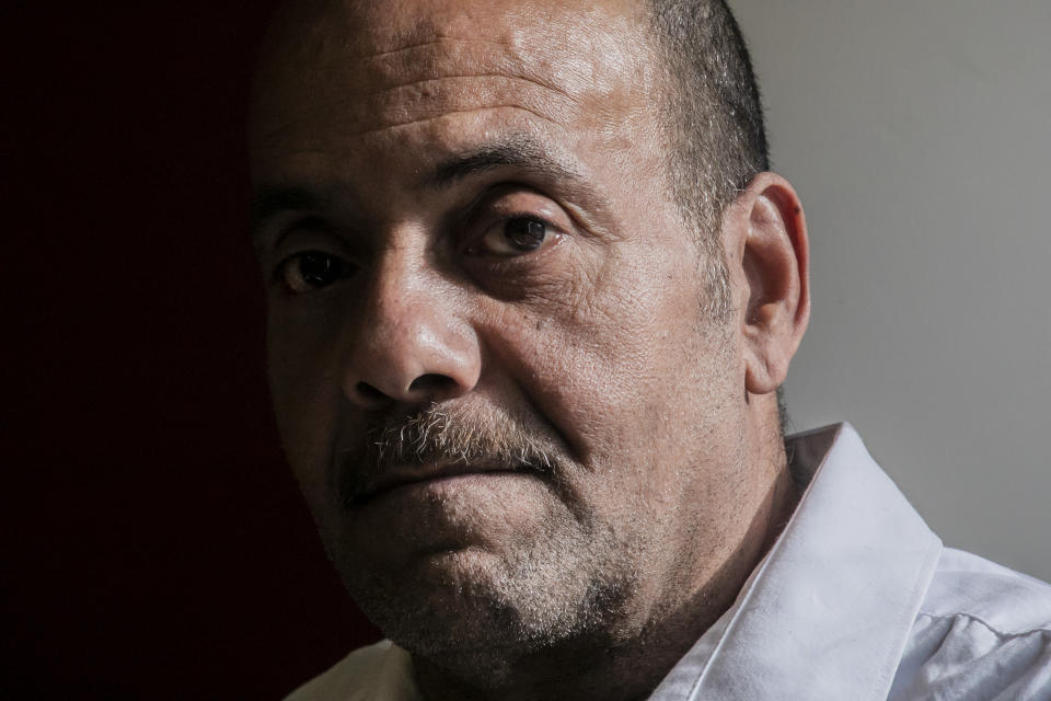 Rafael Ruiz, 60, sits in his lawyer's office at the Innocence Project, after his exoneration last Tuesday of a violent rape charge that sent him to prison for 25 years, Thursday Jan. 30, 2020, in New York. (AP Photo/Bebeto Matthews)