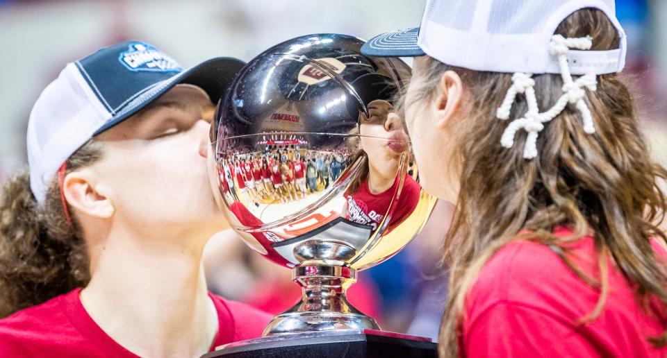 Indiana's Mackenzie Holmes (54) and Grace Berger (34) kiss the Big Ten Championship Trophy after the second half of the Indiana versus Purdue women's basketball game at Simon Skjodt Assembly Hall on Sunday, Feb. 19, 2023.