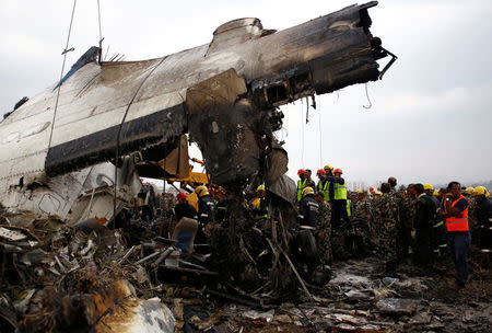 Rescue workers work at the wreckage of a US-Bangla airplane after it crashed at the Tribhuvan International Airport in Kathmandu, Nepal March 12, 2018. REUTERS/ Navesh Chitrakar