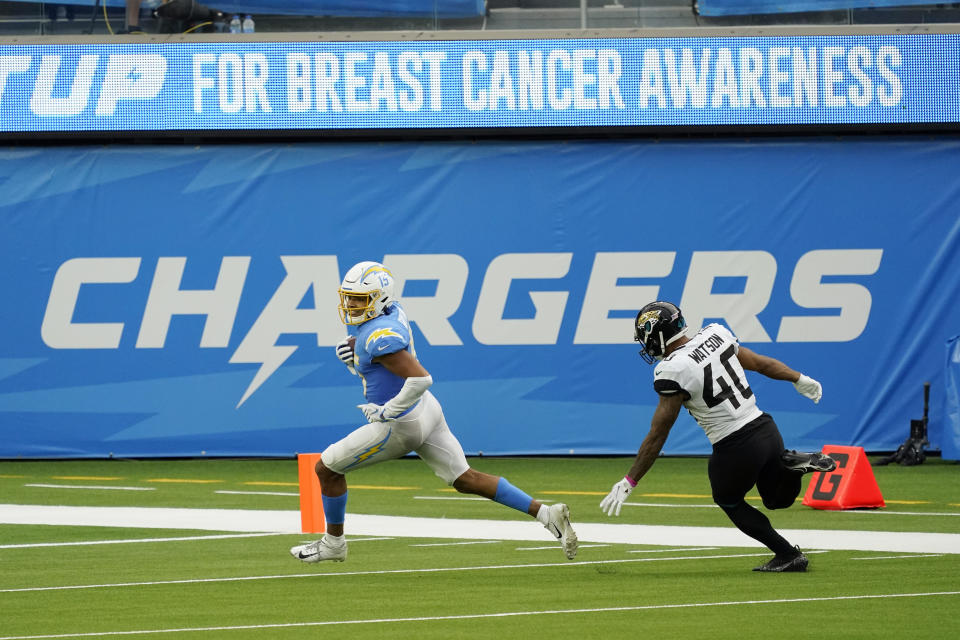 Los Angeles Chargers wide receiver Jalen Guyton (15) scores past Jacksonville Jaguars cornerback Brandon Watson (40) during the second half of an NFL football game Sunday, Oct. 25, 2020, in Inglewood, Calif. (AP Photo/Alex Gallardo )