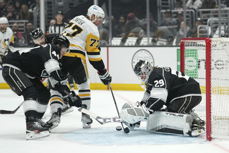 Pittsburgh Penguins center Jeff Carter, center, tries to score on Los Angeles Kings goaltender Pheonix Copley, right, as defenseman Mikey Anderson defends during the first period of an NHL hockey game Saturday, Feb. 11, 2023, in Los Angeles. (AP Photo/Mark J. Terrill)