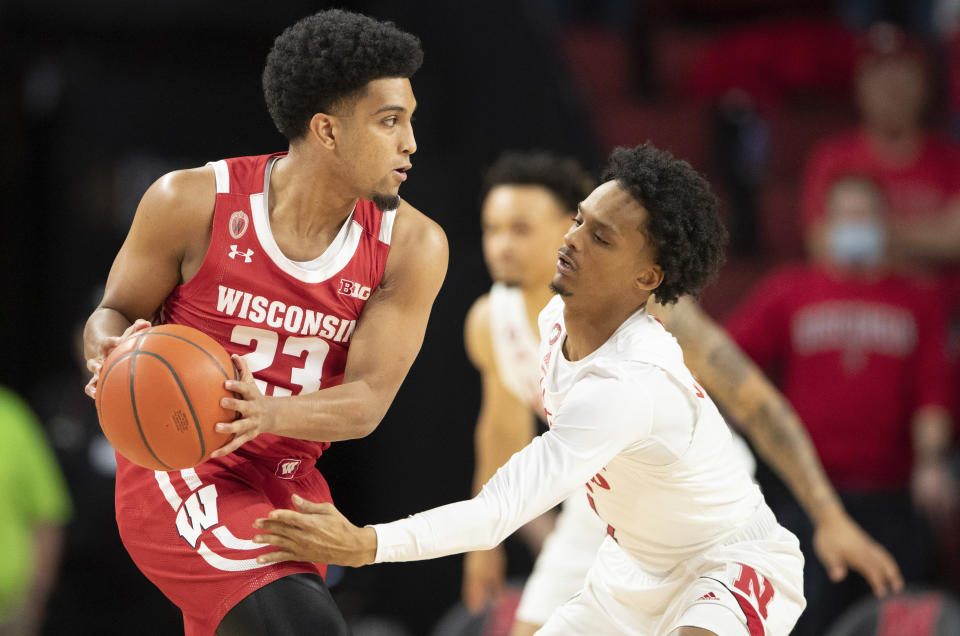 Wisconsin's Chucky Hepburn (23) plays against Nebraska's Alonzo Verge Jr. (1) during the first half of an NCAA college basketball game Thursday, Jan. 27, 2022, in Lincoln, Neb. (AP Photo/Rebecca S. Gratz)