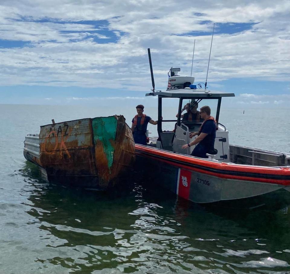 A U.S. Coast Guard crew ties their vessel to a Cuban migrant boat off the ocean side of Tavernier Creek in the Florida Keys Friday, Oct. 14, 2022. It’s one of dozens of migrant vessels to arrive off the Keys over a two-week period.