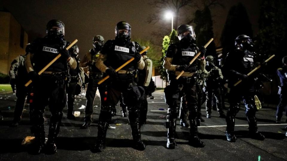 Officers stand guard outside Brooklyn Center Police Department