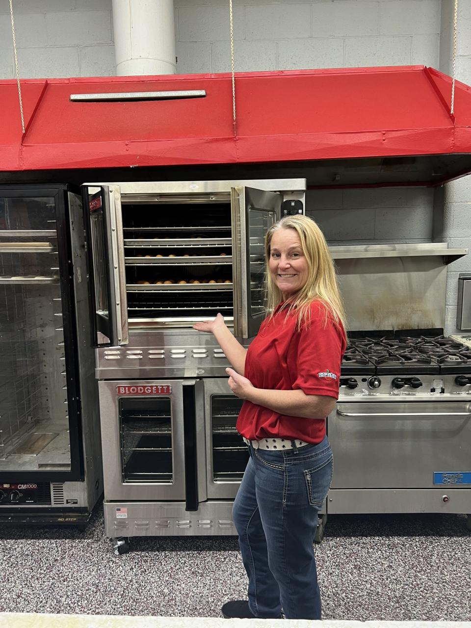 Treva Saucedo, director of nutrition services for Caney Valley Public Schools, shows off the new double-stack convection oven the district purchased after receiving a grant for nearly $30,000.