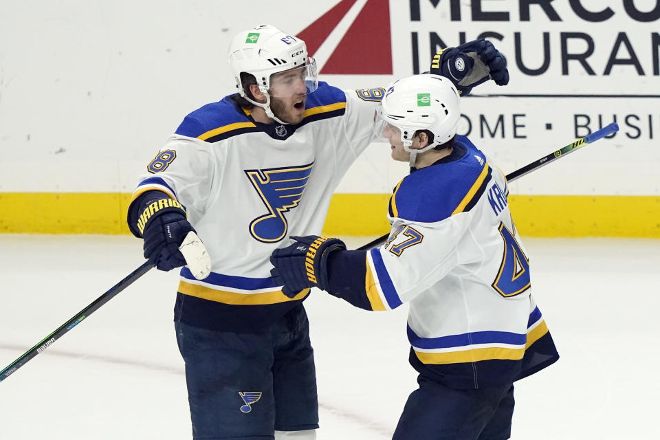 St. Louis Blues' Mike Hoffman, left, celebrates his winning goal with teammate Torey Krug, right, during overtime of an NHL hockey game against the Los Angeles Kings, Friday, March 5, 2021, in Los Angeles. (AP Photo/Marcio Jose Sanchez)