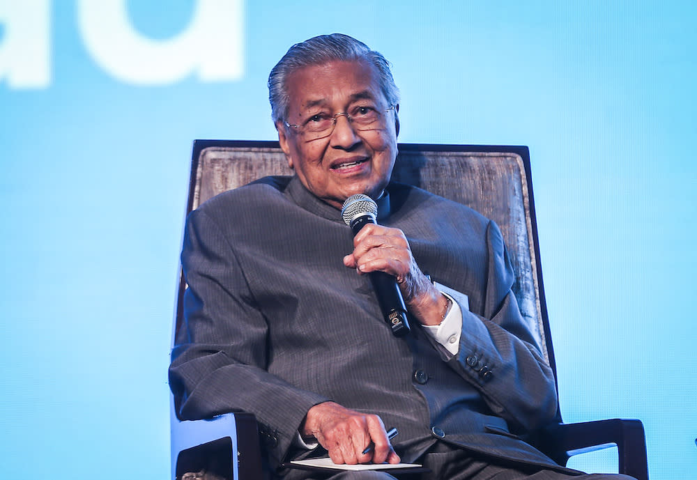 Tun Dr Mahathir Mohamad by his own confession loves to work, but keeps his memory sharp and relaxes by reading — sometimes two books at one time. — Picture by Firdaus Latif