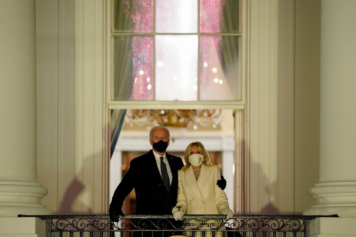 President Joe Biden and first lady Jill Biden watch fireworks light up the sky from the White House on Inauguration Day on Wednesday, Jan. 20, 2021, in Washington.