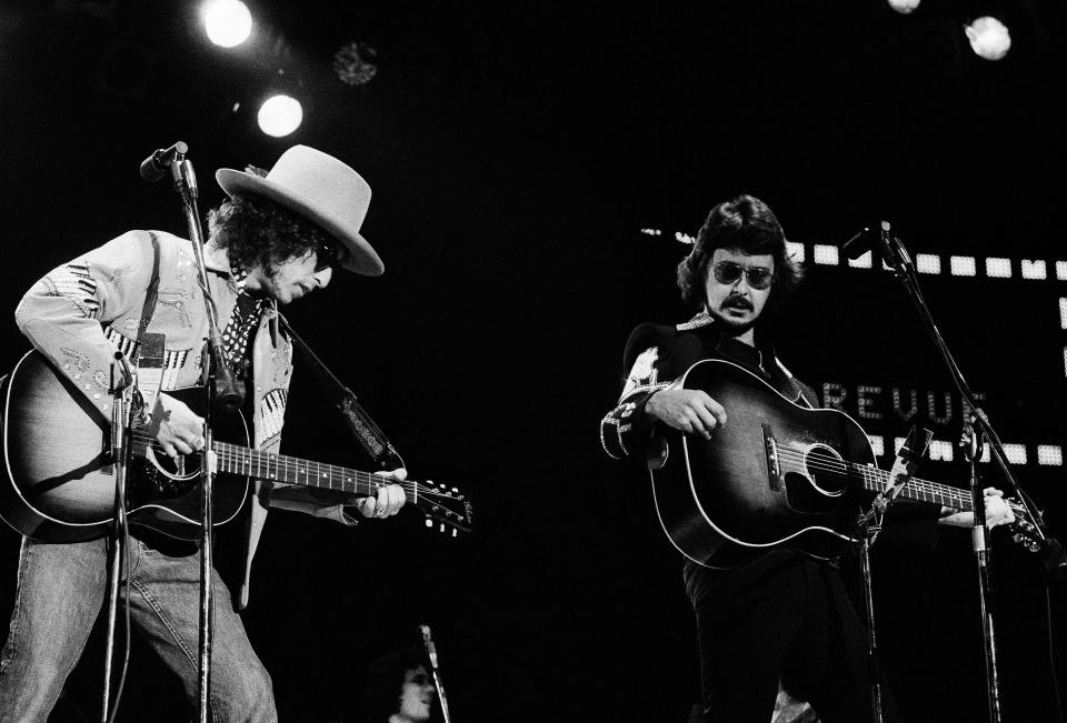 Bob Neuwirth (right) performs with Bob Dylan and the Rolling Thunder Revue at a benefit concert for boxer Rubin Hurricane Carter, January 1976. - Credit: AP