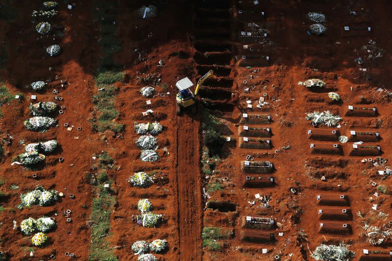 A gravedigger opens new graves with an excavator as the number of dead people rose after the coronavirus disease (COVID-19) outbreak, at Vila Formosa cemetery, Brazil's biggest cemetery, in Sao Paulo