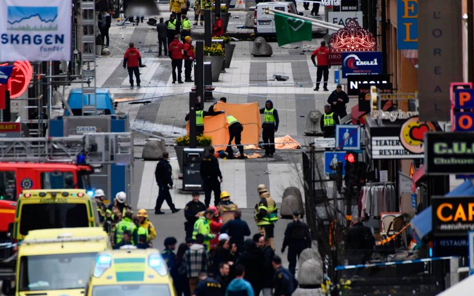 Emergency services work at the scene where a truck crashed into the Ahlens department store  - Credit: Jonathan Nackstrand/AFP