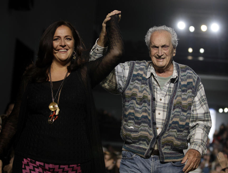 FILE - In this Feb. 27, 2011 file photo Ottavio Missoni, right, and his daughter Angela acknowledge the applause of the audience after presenting their Missoni Fall/Winter 2011 collection, in Milan, Italy. Italian fashion company Missoni says its co-founder, Ottavio Missoni, has died in his home earlier on Thursday, May 9, 2013 in northern Italy. Missoni, who was 92, founded the iconic fashion brand of zigzagged-patterned knitwear along with his wife, Rosita, in 1953. The Missonis are a family fashion dynasty, with the couple’s children and their offspring involved in expanding the brand. (AP Photo/Luca Bruno, File)