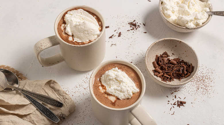 Two cups with hot chocolate and whipped cream on top