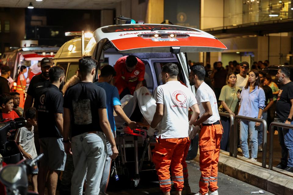 A person is carried on a stretcher outside American University of Beirut Medical Center after several wounded in pager attack in Lebanon on 17 September 2024 (Reuters)