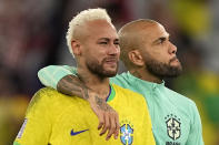 Brazil's Neymar, left, has tears in his face beside Brazil's Dani Alves, right, after losing the World Cup quarterfinal soccer match between Croatia and Brazil, at the Education City Stadium in Al Rayyan, Qatar, Friday, Dec. 9, 2022. (AP Photo/Martin Meissner)