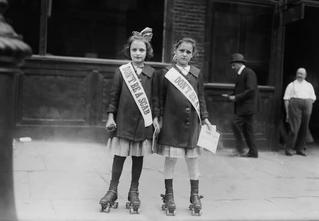 Two young strike sympathizers on roller skates in the U.S. circa 1910s.