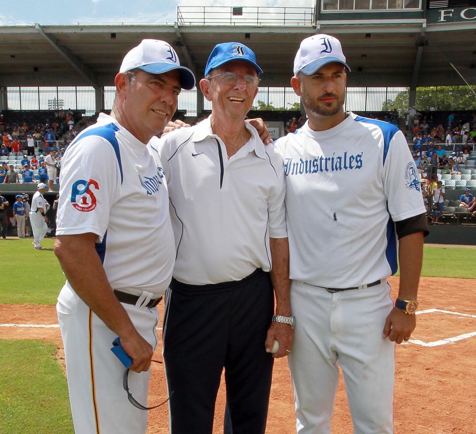 FILE - In this Saturday, Aug. 31, 2013 file photo, three generations of exiled pitchers from the Havana town of Regla, Cuba, from left, Rene Arocha, Manuel Hurtado and Joel Hernandez, pose before a baseball game between Cuban baseball team Industriales and a team of former players now living in exile in Fort Lauderdale, Fla. Cubans can sign under rules similar to what players from Japan, South Korea and Taiwan face, according to a new agreement between Major League Baseball, its players’ association and the Cuban Baseball Federation. Players from Cuba would be allowed to sign big league contracts without defecting.(Pedro Portal/El Nuevo Herald via AP, File)