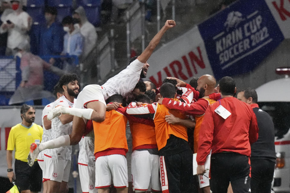 Tunisian players celebrate after a goal scored by Mohamed Ali Ben Romdhane during the match between Japan and Tunisia at the Kirin Cup soccer tournament in Suita, west Japan, Tuesday, June 14, 2022. (AP Photo/Eugene Hoshiko)