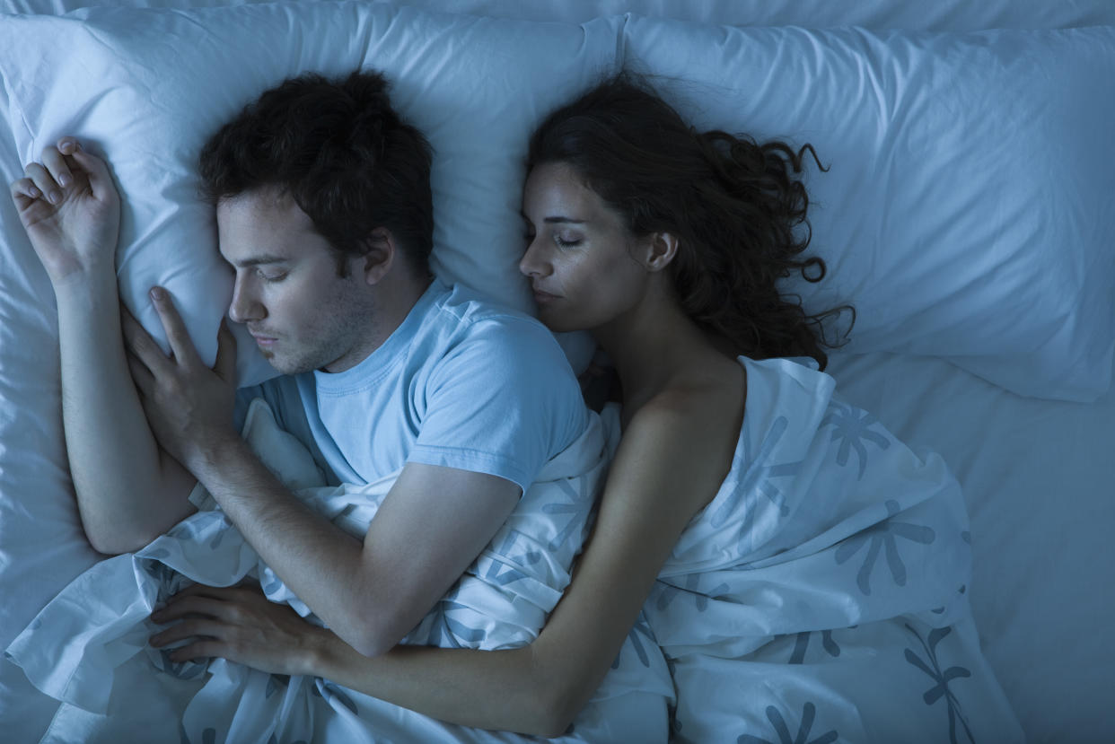 Spooning and cuddling in bed releases a 'happy hormone' that can lead to several health benefits. (Getty Images)