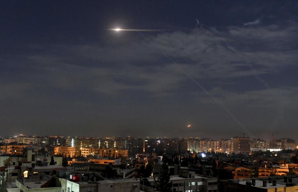 In this photo released by the Syrian official news agency SANA, shows missiles flying into the sky near international airport, in Damascus, Syria, Monday, Jan. 21, 2019. In a very unusual move, the Israeli military has issued a statement saying it is attacking Iranian military targets in Syria. It is also warning Syrian authorities not to retaliate against Israel. (SANA via AP)