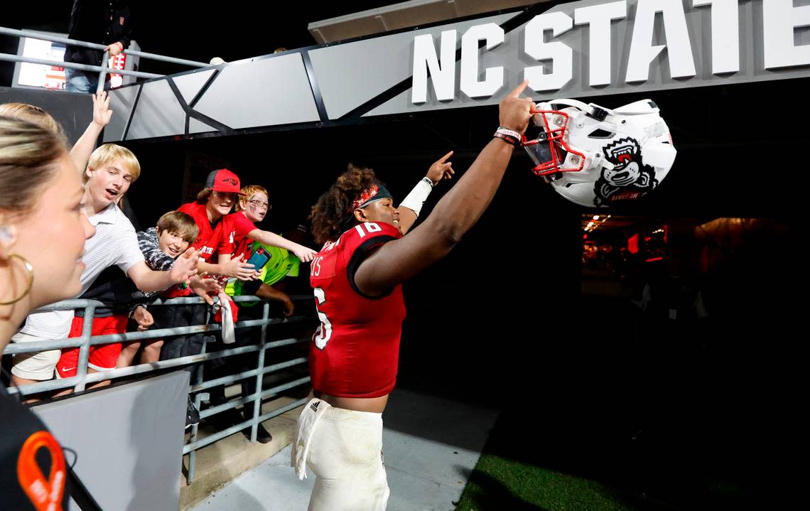 N.C. State quarterback MJ Morris (16) acknowledges the crowds as he heads to the locker room after N.C. State’s 30-21 victory over Wake Forest at Carter-Finley Stadium in Raleigh, N.C., Saturday, Nov. 5, 2022.