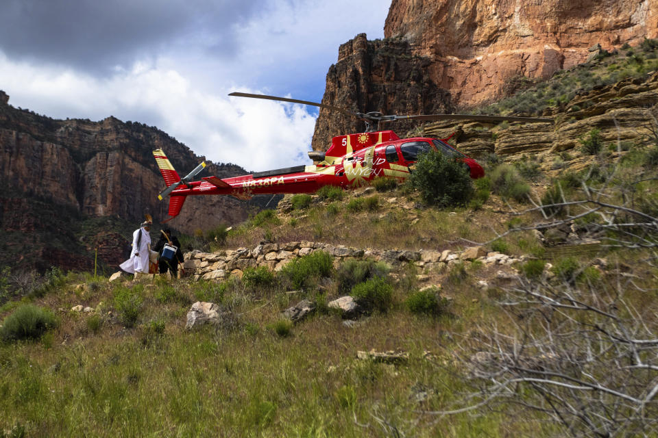 A helicopter carrying members of the Havasupai Tribe and others arrives below the rim of Grand Canyon National Park on Friday, May 5, 2023. The tribe held a blessing ceremony to mark the renaming of a popular campground from Indian Garden to Havasupai Gardens. (AP Photo/Ty O'Neil)