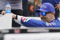 Tony Kanaan, of Brazil, stretches during qualifications for the Indianapolis 500 auto race at Indianapolis Motor Speedway, Saturday, May 21, 2022, in Indianapolis. (AP Photo/Darron Cummings)