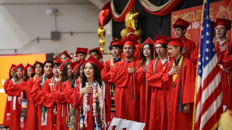 Ashley Becerril at front of bottom row and the other students start the ceremony with a flag salute. Coast Union awarded 30 diplomas in Cambria on June 5, 2024.