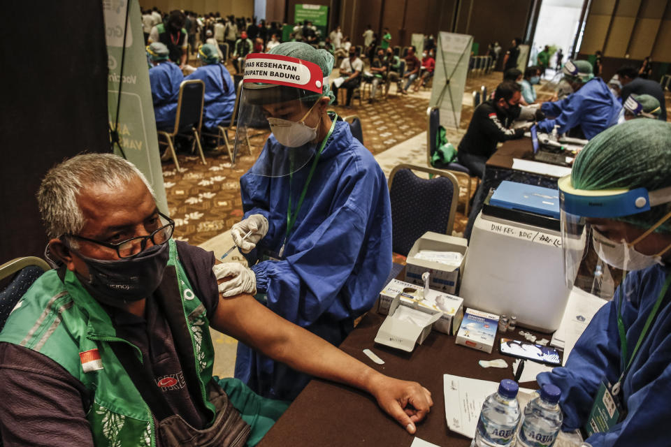 An online bike driver receive a dose of Sinovac COVID-19 vaccine during mass vaccination program in Nusa Dua, Bali, Indonesia on February 27 2021. Indonesia government is holding massive coronavirus vaccination in Bali as part of preparation for reopening tourism and international flights.   (Photo by Johanes Christo/NurPhoto via Getty Images)