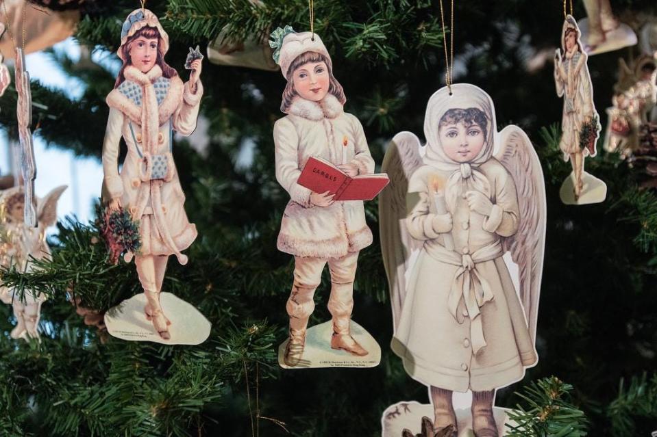 Printed Victorian figures adorn Christmas trees at the Brennan House as they and the Conrad-Caldwell House Museum on St. James Court join up for a Victorian Holiday Tour of their mansions.