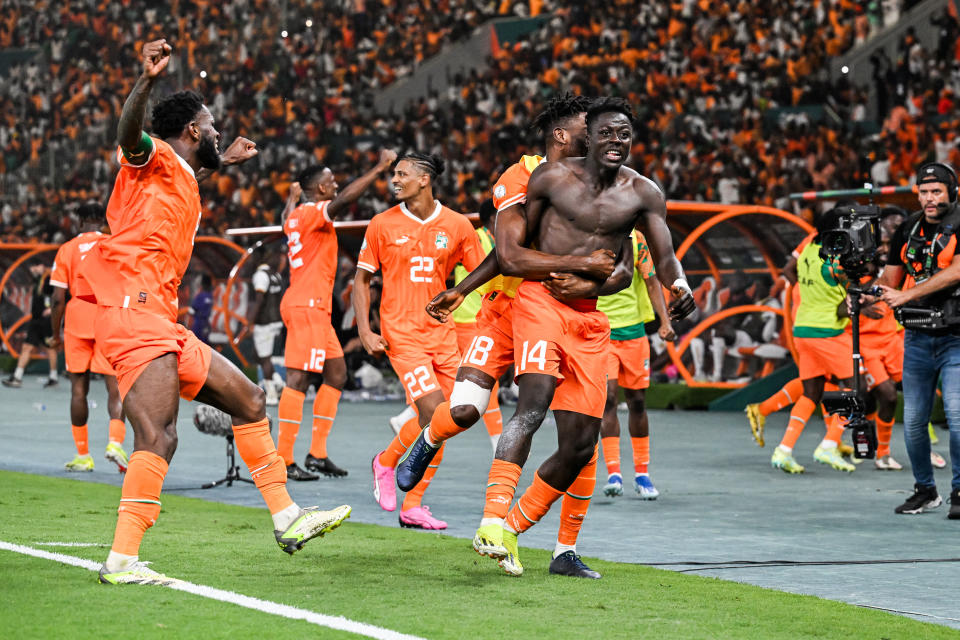 TOPSHOT - Ivory Coast's forward #14 Oumar Diakite (C) takes his jersey off as he celebrates with teammates after scoring his team's second goal during the Africa Cup of Nations (CAN) 2024 quarter-final football match between Mali and Ivory Coast at the Stade de la Paix in Bouake on February 3, 2024. (Photo by Issouf SANOGO / AFP) (Photo by ISSOUF SANOGO/AFP via Getty Images)