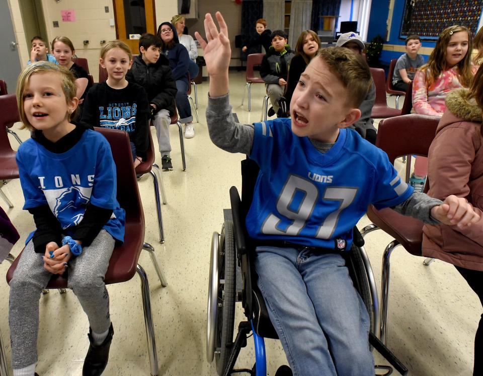 Barnes Elementary third grader Conner Adcock (right) sings out loud with Kayle Hayhurst (left) and his classmates. They sang the Disney song "Let it Go" in music class on Detroit Lions Day. Flat Rock Community Schools shouted out for the Detroit Lions Thursday as part of spirit week. Conner wore the number 97 to show his support for Aidan Hutchinson, who calls Conner his good luck charm and is a Hutch Hero.