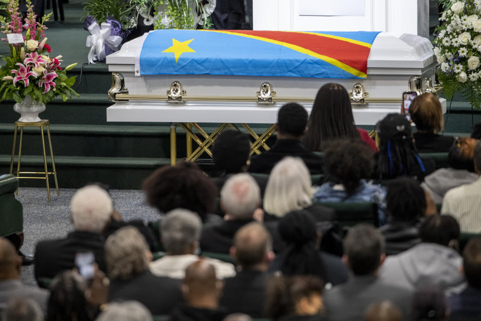 The casket holding the remains of Patrick Lyoya is on display during the funeral at the Renaissance Church of God in Christ Family Life Center in Grand Rapids, Mich. on Friday, April 22, 2022. The Rev. Al Sharpton demanded that authorities publicly identify the Michigan officer who killed Patrick Lyoya, a Black man and native of Congo who was fatally shot in the back of the head after a struggle, saying at Lyoya's funeral Friday: “We want his name!" (Cory Morse/The Grand Rapids Press via AP)