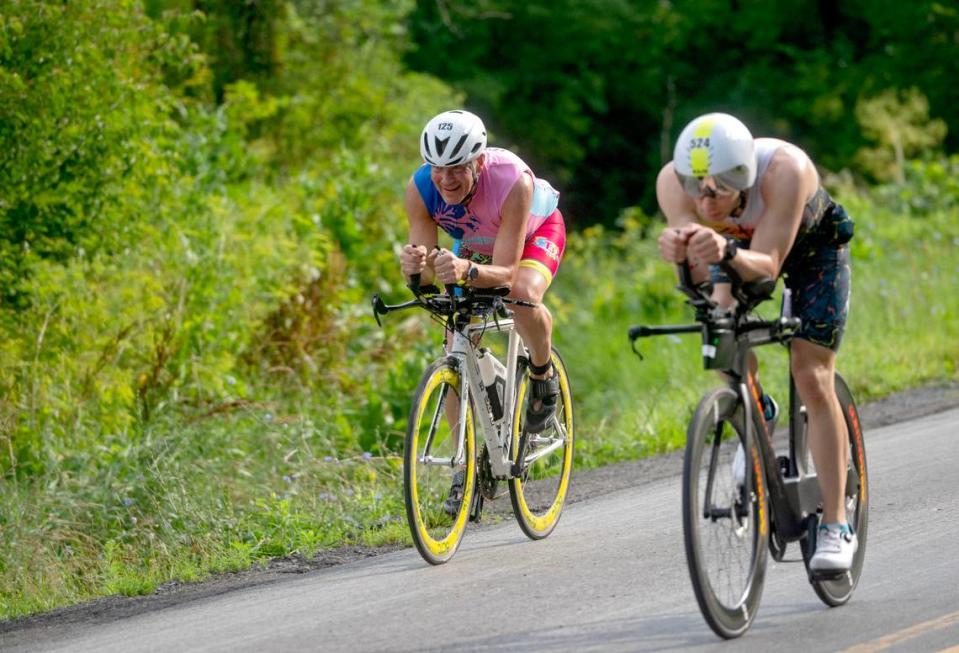 Cyclists cruise along Jacksonville Road as part of the 56 mile ride in the Ironman 70.3 Pennsylvania Happy Valley on Sunday, June 30, 2024.